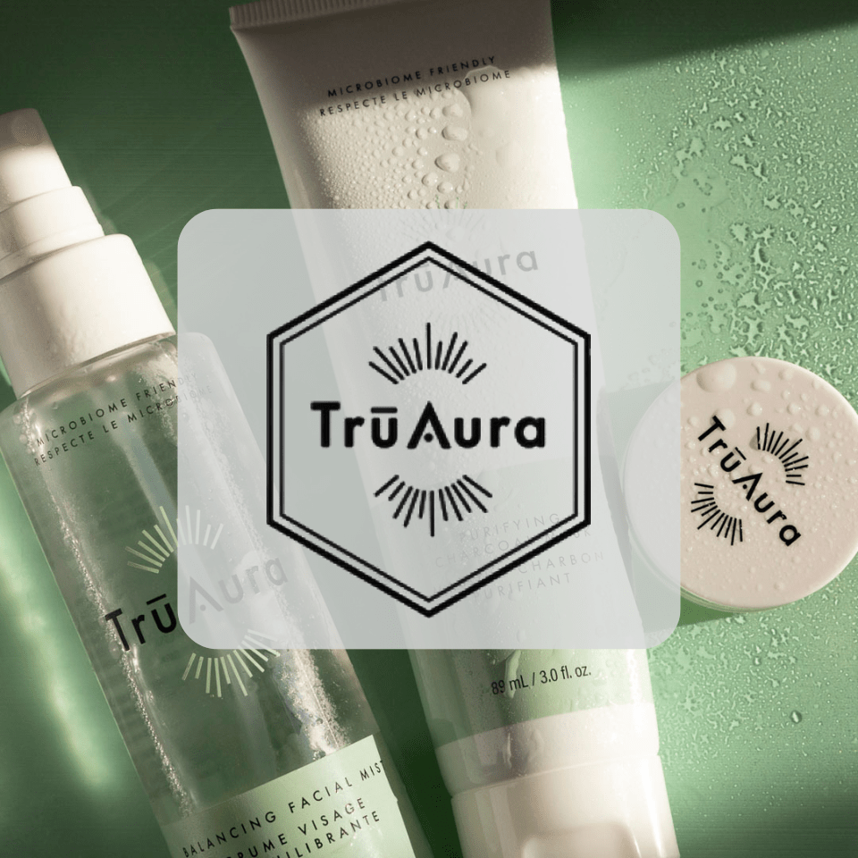 TruAura skincare products displayed alongside the Youngevity and TruAura logos, celebrating TruAura's official welcome into the Youngevity family.